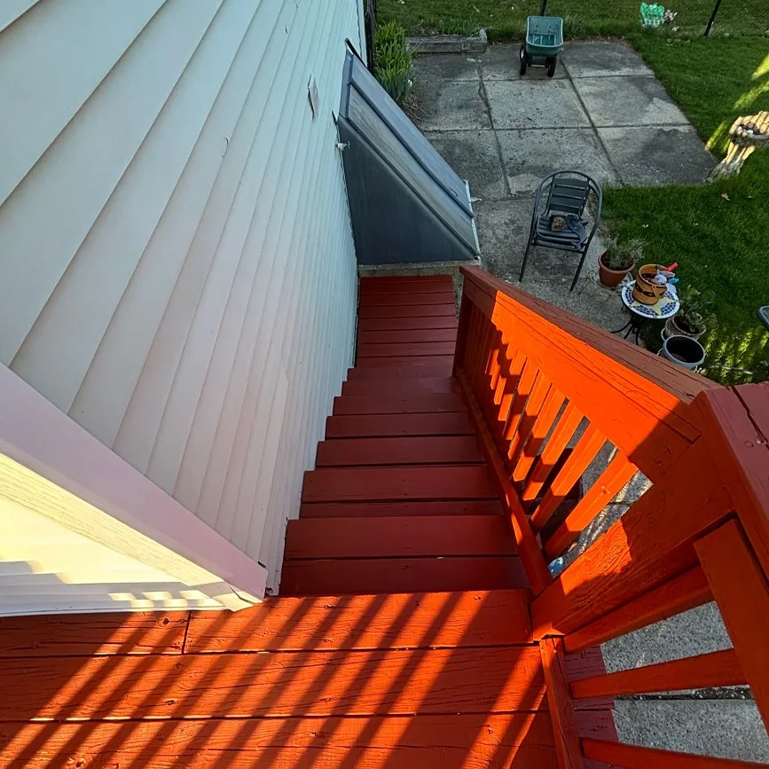 Refinished deck stairs and railing by Tauro Builders