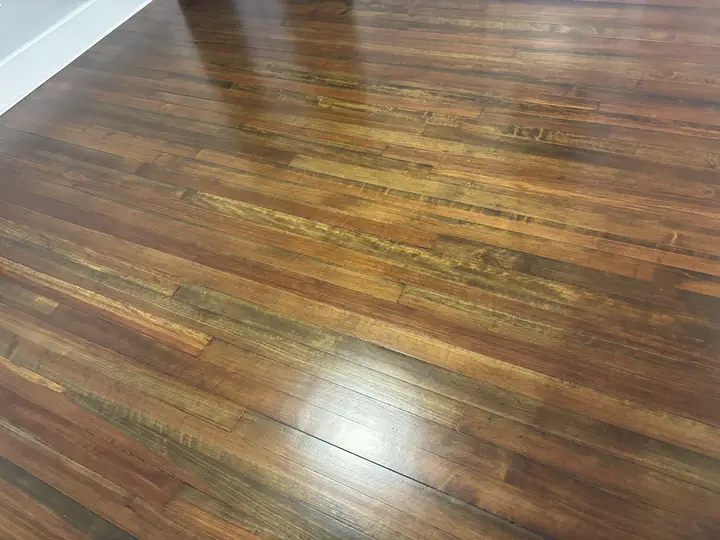 Refinished wide-plank hardwood by Tauro Builders