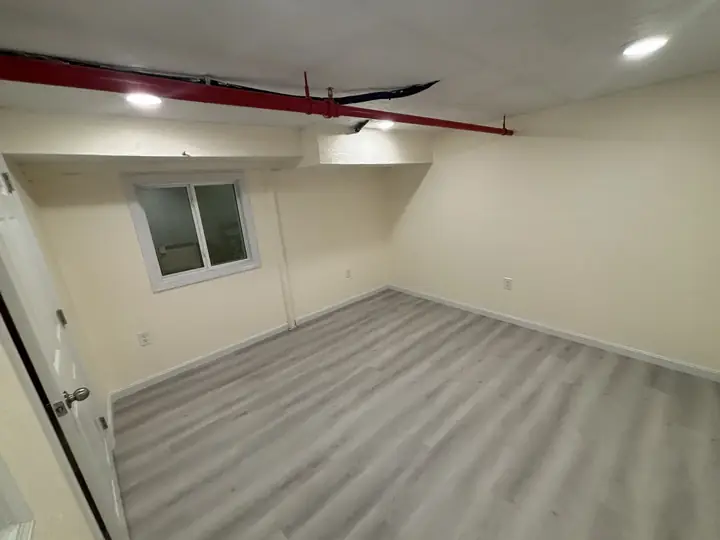 Basement finished with luxury vinyl flooring by Tauro Builders