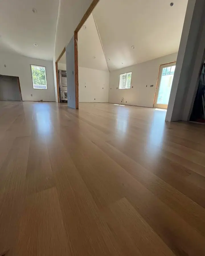 Vaulted room with light flooring by Tauro Builders