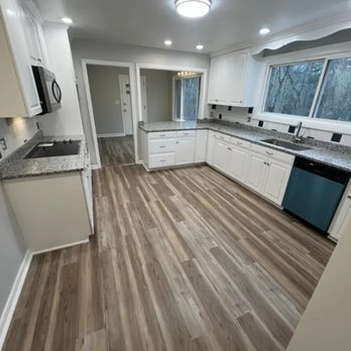 Kitchen remodel with granite and vinyl plank floors by Tauro Builders